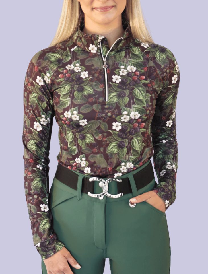 A rider in a Dapplebay Blackberry Daze top and green breeches