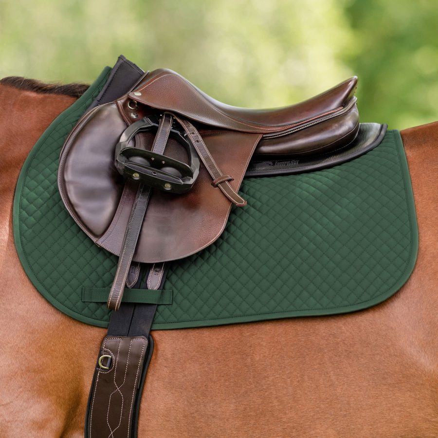 A brown saddle on a hunter green EquiFit Essential All Purpose Square Pad on a bay horse
