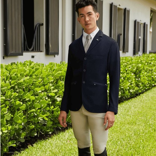 A man in a show coat and tall boots